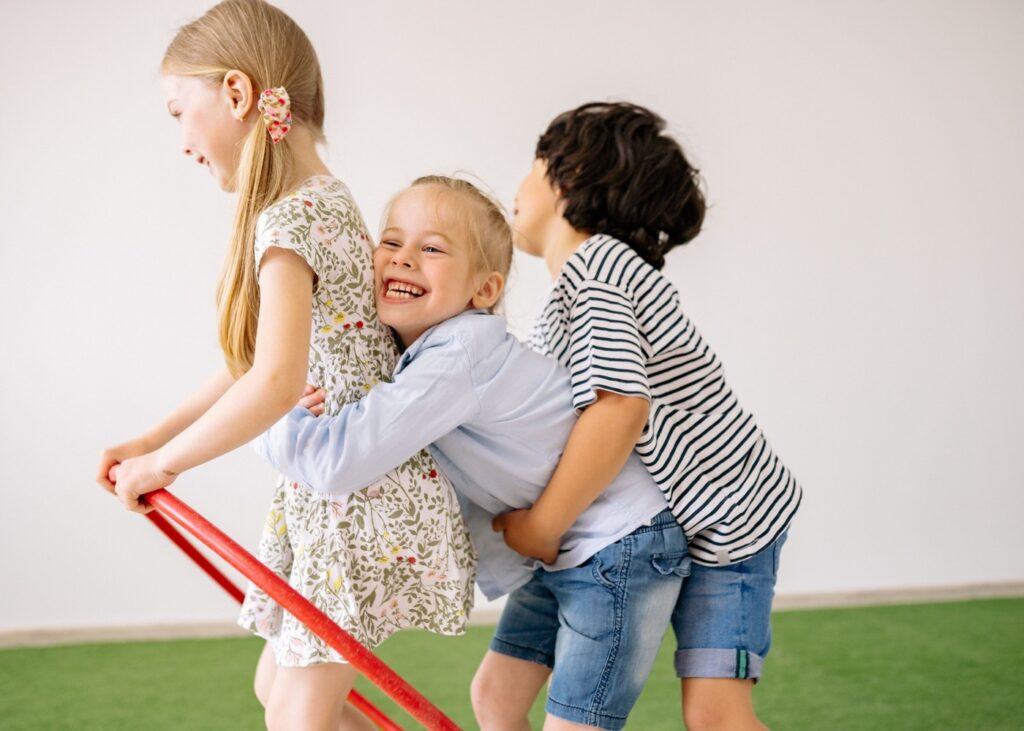 https://www.pexels.com/photo/two-girls-and-a-boy-having-fun-8613065/