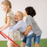 https://www.pexels.com/photo/two-girls-and-a-boy-having-fun-8613065/